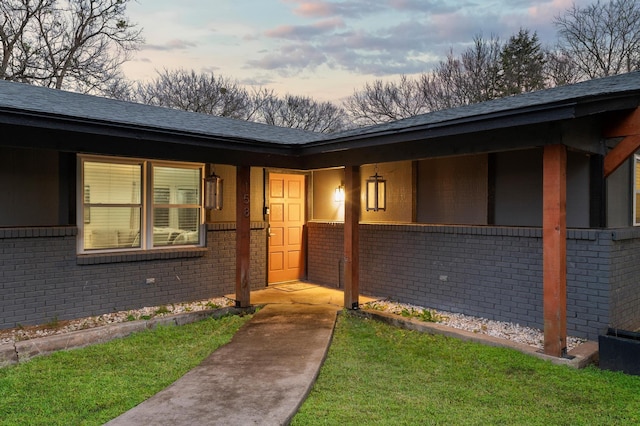 exterior entry at dusk with a yard