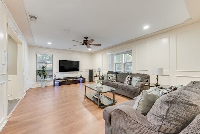 living room with ceiling fan and light hardwood / wood-style floors