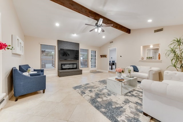 tiled living room featuring a large fireplace, vaulted ceiling with beams, and ceiling fan