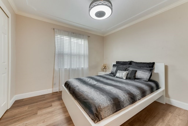 bedroom with crown molding and wood-type flooring