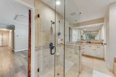 bathroom with hardwood / wood-style flooring, vanity, and a shower with shower door