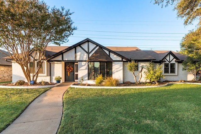 english style home with a front yard