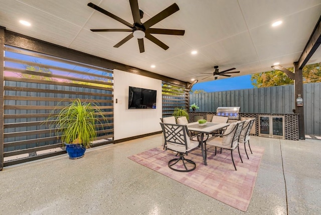 view of patio with an outdoor kitchen and ceiling fan