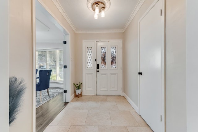 entryway featuring crown molding and light tile patterned flooring