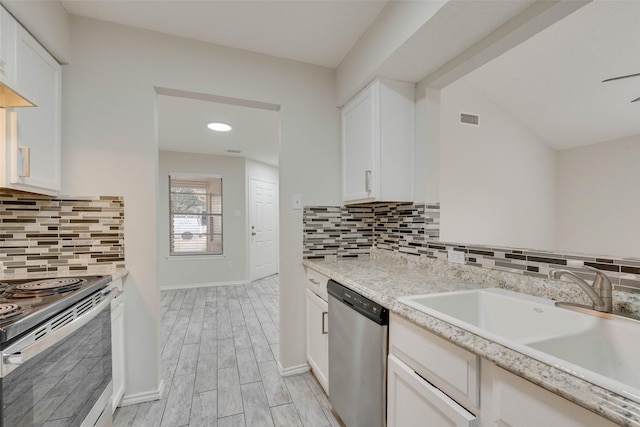 kitchen with sink, tasteful backsplash, lofted ceiling, white cabinets, and appliances with stainless steel finishes