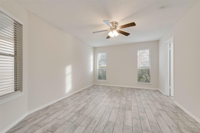 unfurnished room with a textured ceiling, light hardwood / wood-style floors, and ceiling fan