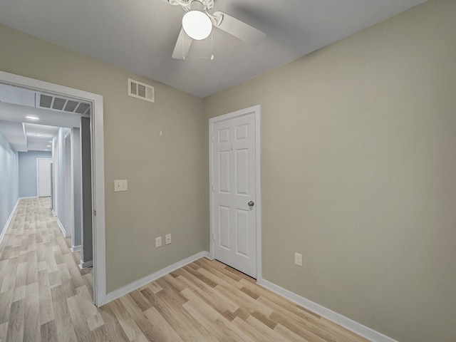 spare room featuring ceiling fan and light wood-type flooring