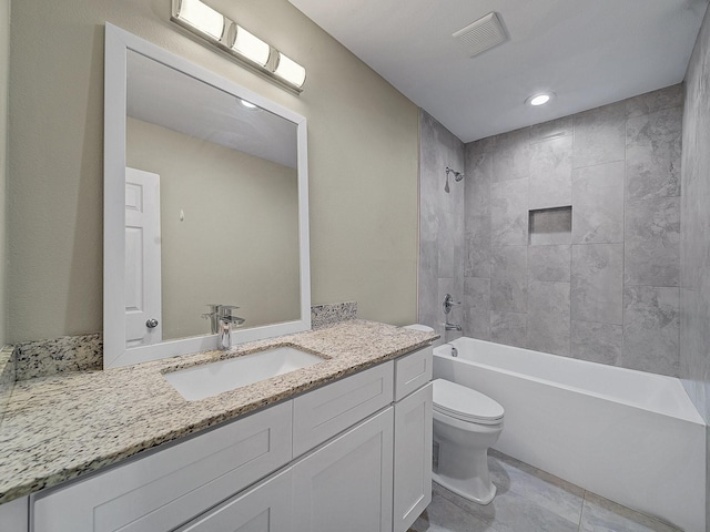 full bathroom with tile patterned flooring, vanity, toilet, and tiled shower / bath