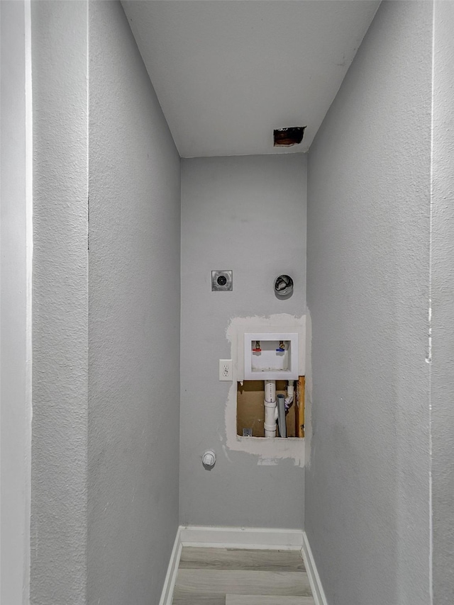 washroom featuring hookup for a washing machine, wood-type flooring, electric dryer hookup, and gas dryer hookup