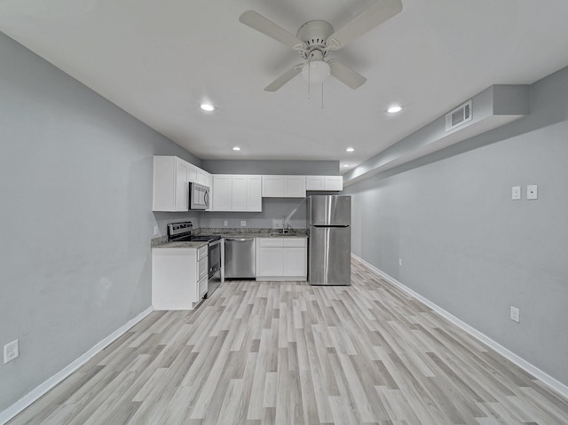 kitchen with white cabinetry, ceiling fan, dark stone counters, appliances with stainless steel finishes, and light wood-type flooring