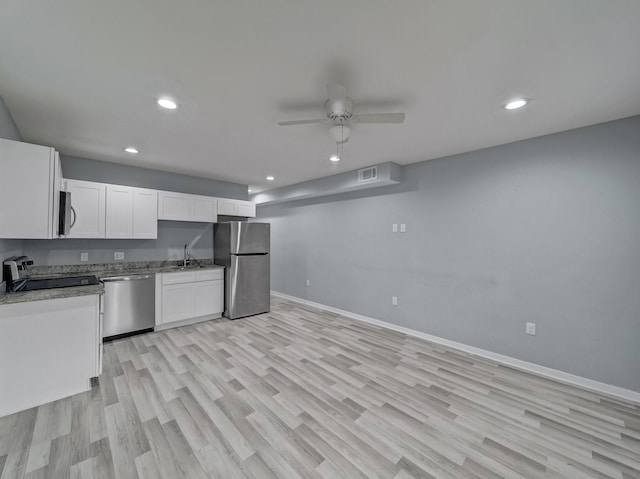 kitchen featuring appliances with stainless steel finishes, ceiling fan, sink, light hardwood / wood-style flooring, and white cabinets