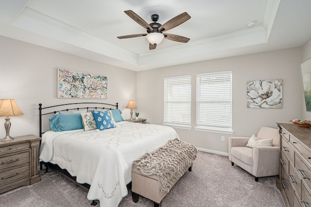 bedroom with light colored carpet, a raised ceiling, ceiling fan, and crown molding