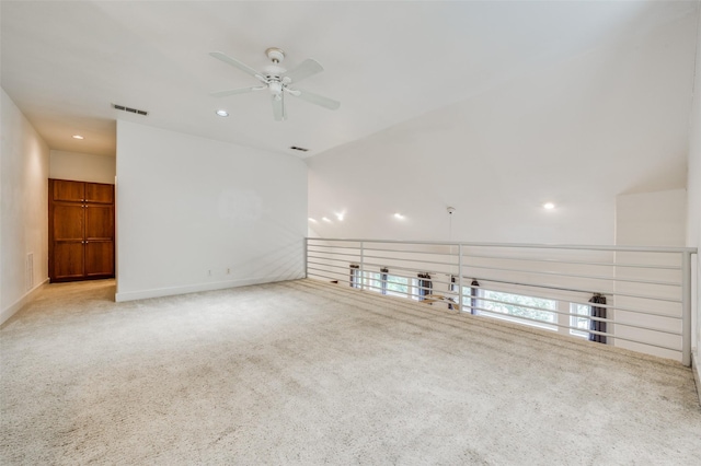 unfurnished living room featuring ceiling fan and light carpet