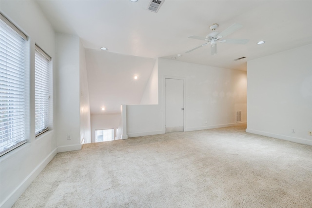 carpeted spare room featuring ceiling fan