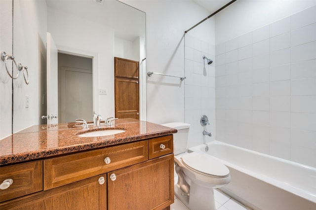 full bathroom featuring tile patterned flooring, tiled shower / bath, vanity, and toilet