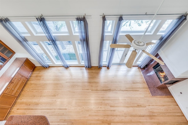 unfurnished living room featuring plenty of natural light and light wood-type flooring