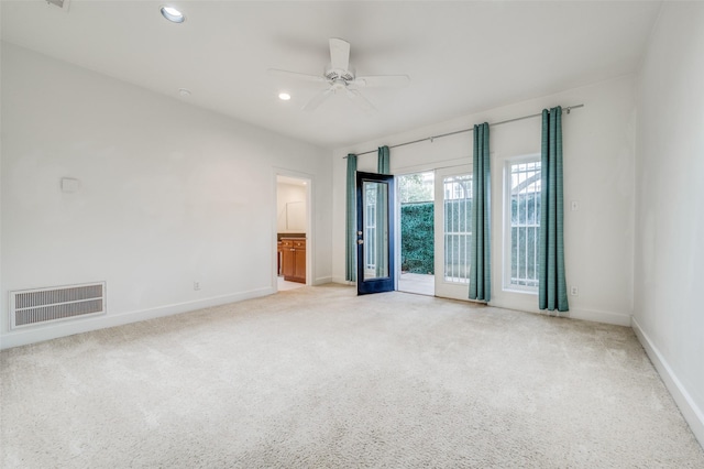 unfurnished room featuring ceiling fan and light colored carpet