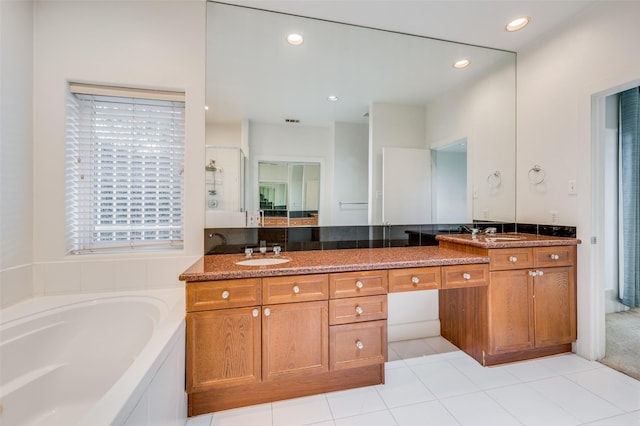 bathroom featuring plus walk in shower, vanity, and tile patterned floors