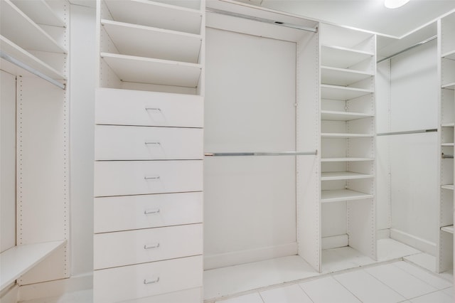 spacious closet with light tile patterned floors