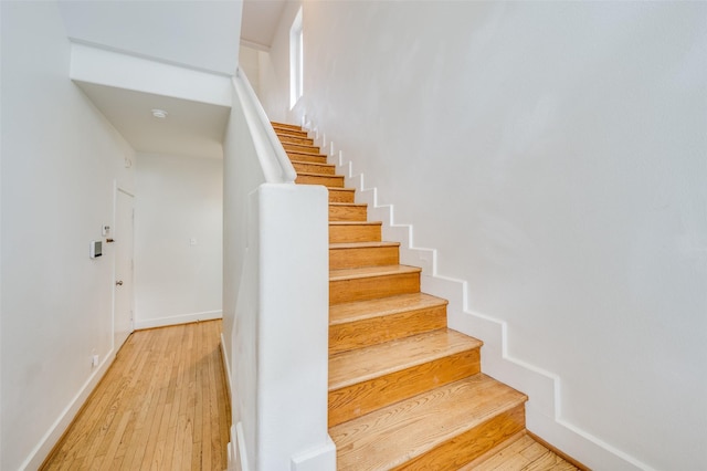 stairs featuring wood-type flooring