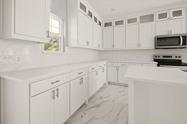 1012 Joe Bailey, Royse City, TX 75189 - kitchen with appliances with stainless steel finishes, light marble finish flooring, white cabinets, and light stone countertops