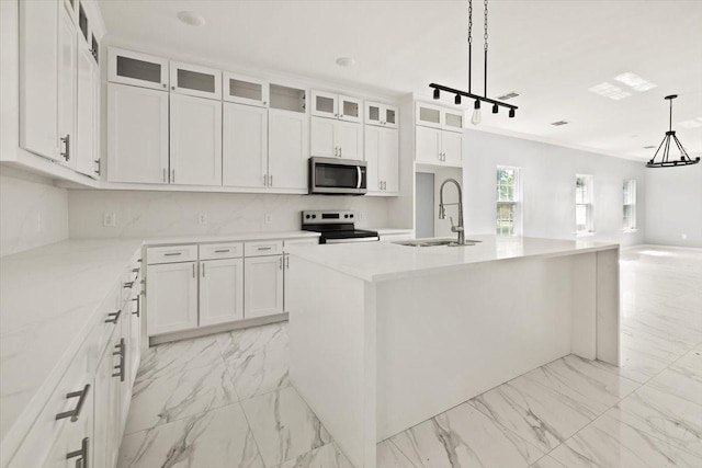 1012 Joe Bailey, Royse City, TX 75189 - kitchen with appliances with stainless steel finishes, a sink, light marble finish floors, white cabinets, and an island with sink