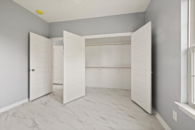 1012 Joe Bailey, Royse City, TX 75189 - unfurnished bedroom featuring marble finish floors, baseboards, and a closet