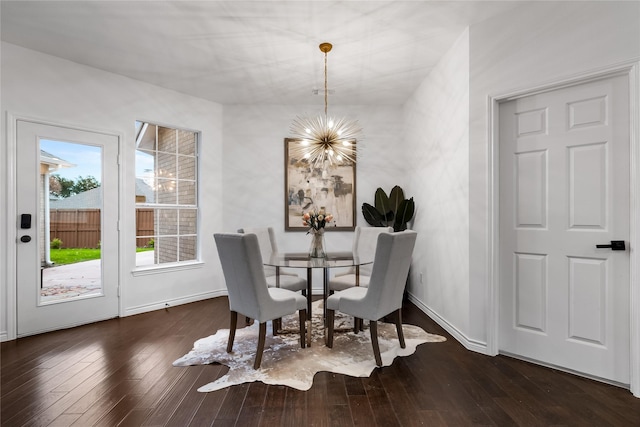 dining area featuring dark wood-type flooring and a chandelier