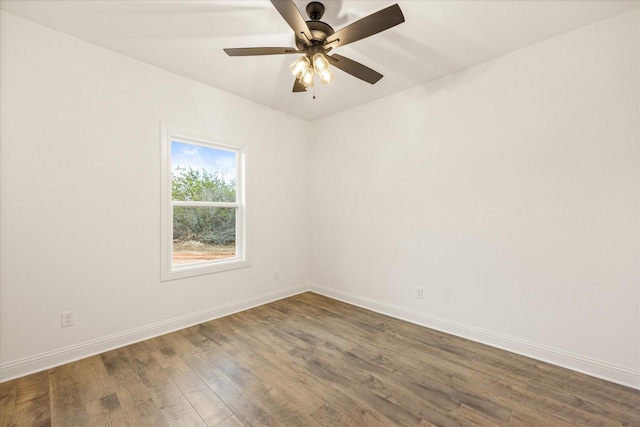 empty room with dark hardwood / wood-style floors and ceiling fan