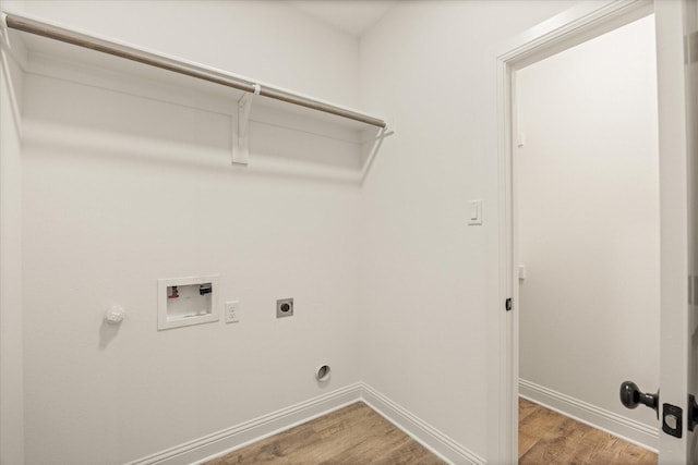 laundry room with hardwood / wood-style floors, gas dryer hookup, electric dryer hookup, and washer hookup