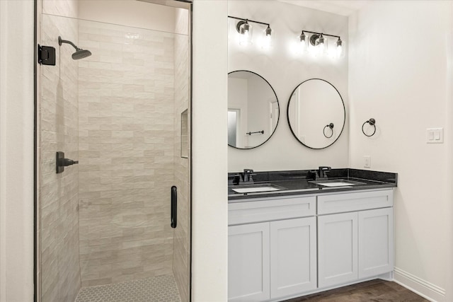 bathroom featuring vanity, a shower with shower door, and hardwood / wood-style floors