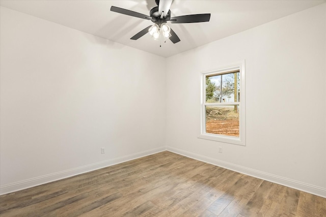 spare room featuring hardwood / wood-style flooring and ceiling fan