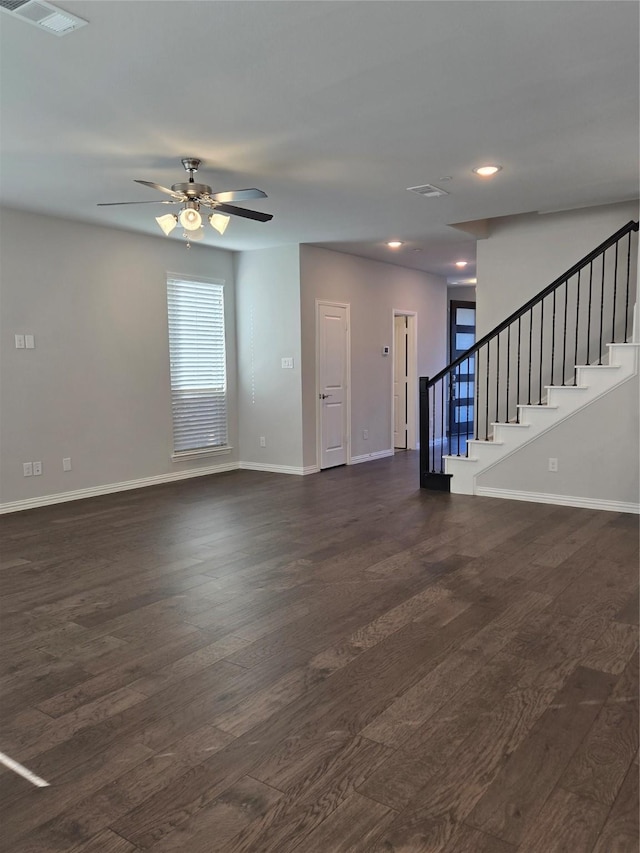 unfurnished living room with dark wood-type flooring and ceiling fan