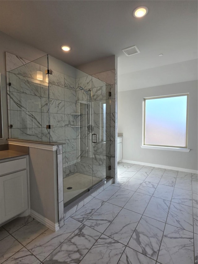 bathroom with vanity and a shower with shower door