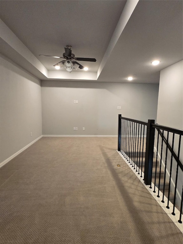 basement featuring carpet floors and ceiling fan