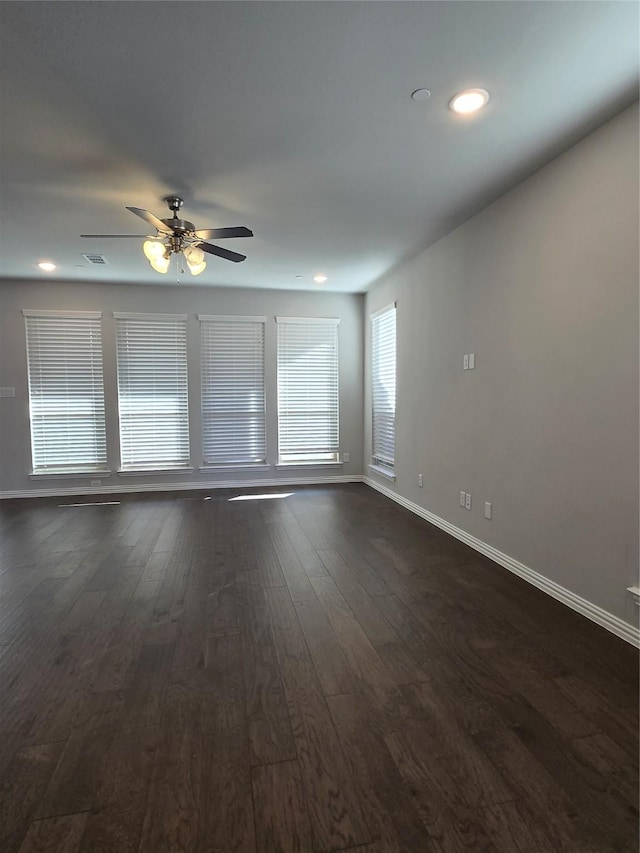 unfurnished room with ceiling fan and dark hardwood / wood-style flooring