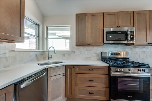 kitchen with backsplash, sink, and stainless steel appliances