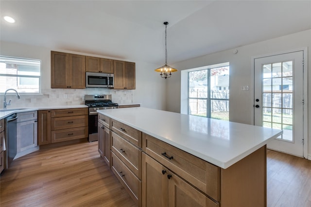 kitchen with plenty of natural light, a kitchen island, and appliances with stainless steel finishes