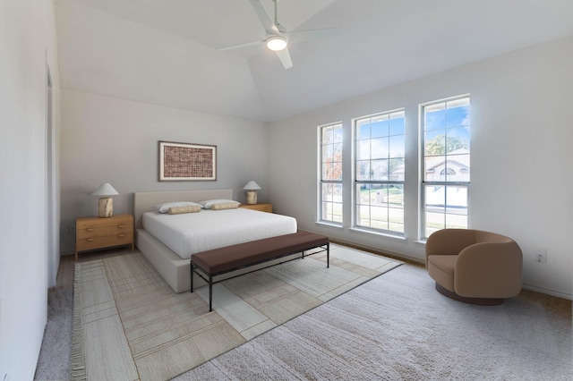 carpeted bedroom featuring ceiling fan and vaulted ceiling