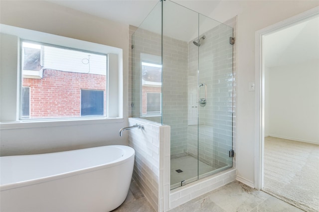 bathroom with plus walk in shower and a wealth of natural light