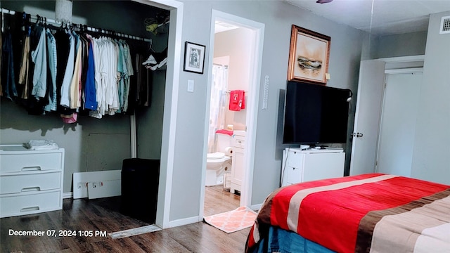 bedroom with hardwood / wood-style floors, a closet, and ensuite bathroom