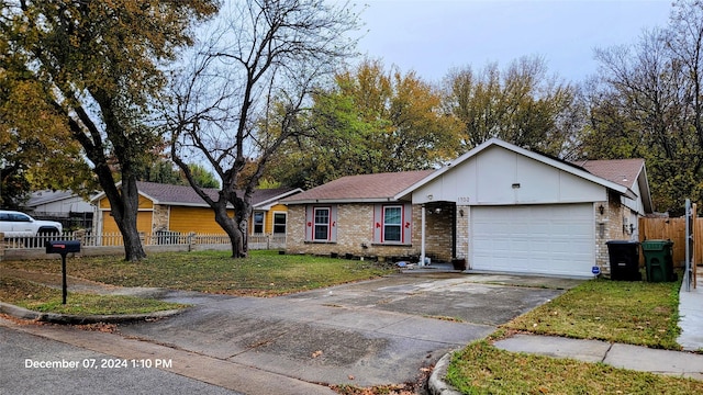 ranch-style house featuring a garage and a front yard