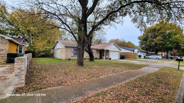 view of front of house featuring a garage and a front lawn