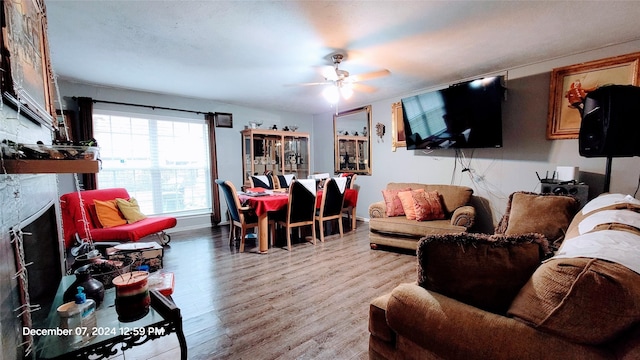 living room with light hardwood / wood-style flooring and ceiling fan