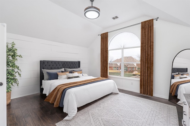 bedroom with dark wood-type flooring and lofted ceiling