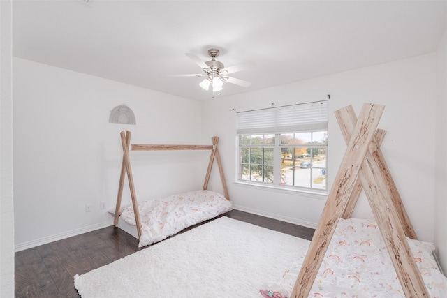 unfurnished bedroom with dark wood-type flooring and ceiling fan