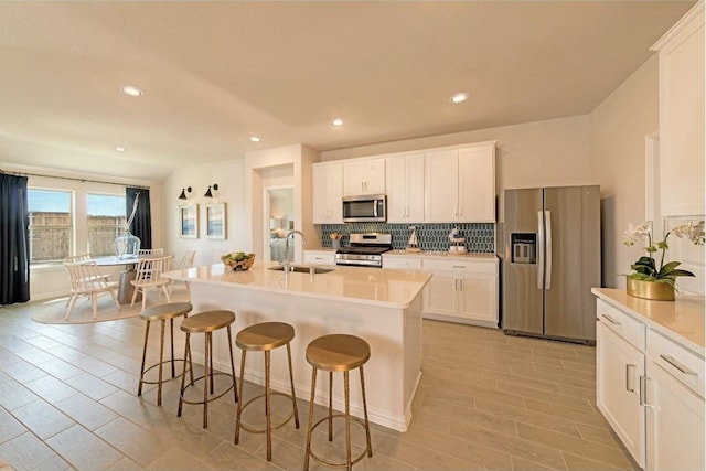 living room featuring sink, vaulted ceiling, and light hardwood / wood-style flooring