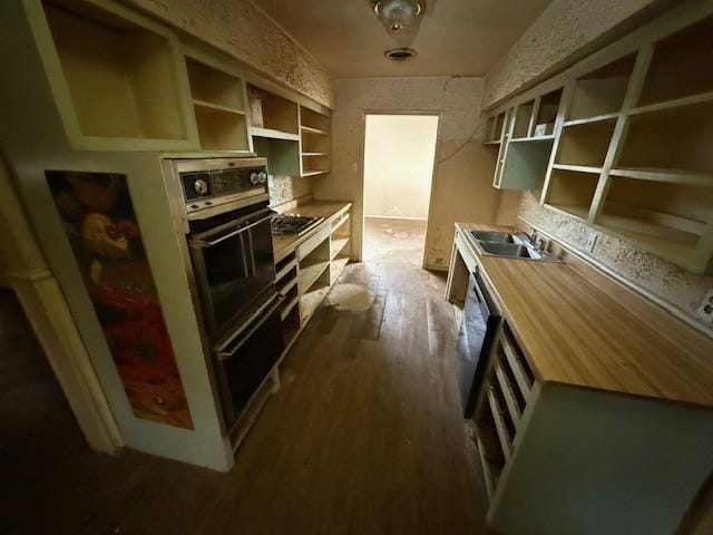 kitchen featuring dark hardwood / wood-style flooring, black appliances, and sink