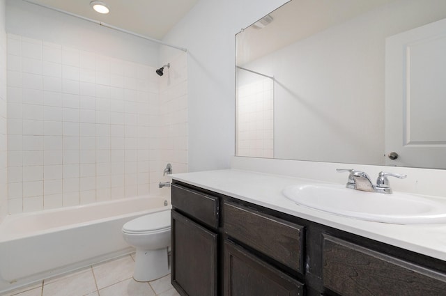 full bathroom featuring tile patterned floors, vanity, tiled shower / bath combo, and toilet