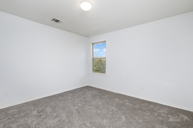 unfurnished room with dark carpet